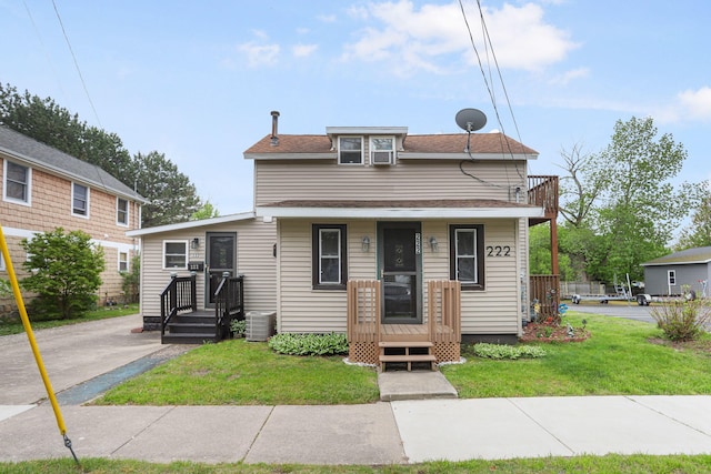 222 Oak St, South Haven, MI 49090 - view of front of home with a front yard, a balcony, central AC unit, and covered porch
