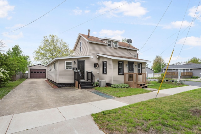 222 Oak St, South Haven, MI 49090 - view of front of property featuring a detached garage, an outdoor structure, a front lawn, central AC, and asphalt driveway