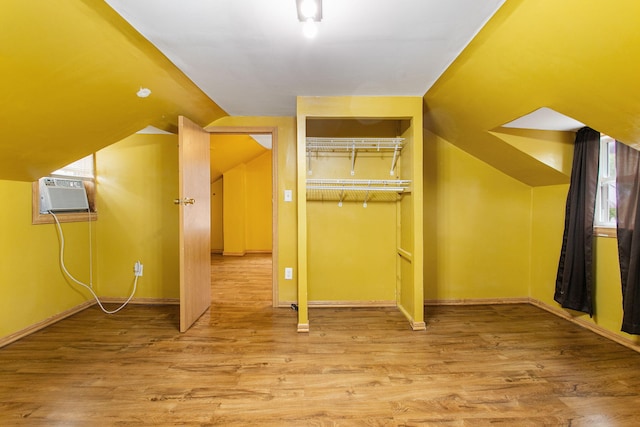 222 Oak St, South Haven, MI 49090 - bonus room with light wood-style flooring, baseboards, lofted ceiling, and an AC wall unit