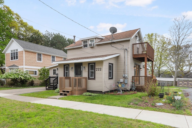 222 Oak St, South Haven, MI 49090 - view of front of house featuring a balcony, a front lawn, and a porch
