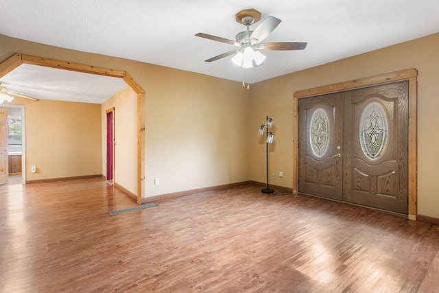 222 Oak St, South Haven, MI 49090 - entrance foyer with ceiling fan, light wood-style flooring, baseboards, and arched walkways