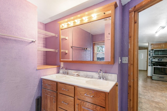 222 Oak St, South Haven, MI 49090 - full bathroom with double vanity and a textured wall