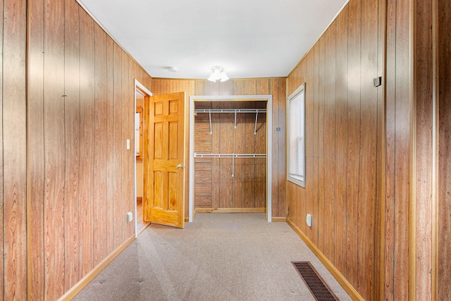 222 Oak St, South Haven, MI 49090 - unfurnished bedroom featuring wood walls, a closet, carpet floors, and baseboards
