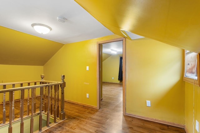 222 Oak St, South Haven, MI 49090 - corridor with an upstairs landing, wood finished floors, lofted ceiling, and baseboards