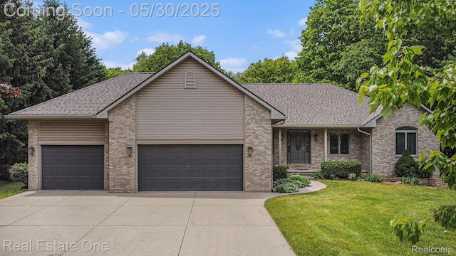 5305 Fern Dr, Fenton, MI 48430 - view of front of home featuring driveway, an attached garage, a front lawn, and brick siding