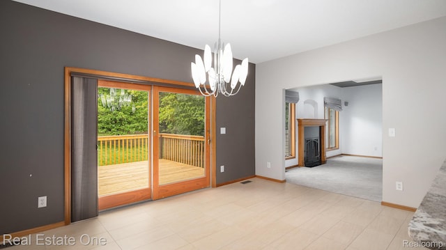 5305 Fern Dr, Fenton, MI 48430 - unfurnished dining area with a chandelier, baseboards, a fireplace, and light colored carpet