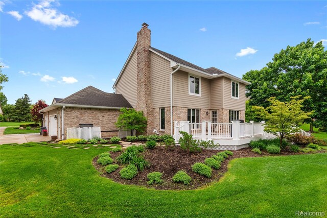 295 Oakbridge Dr, Rochester, MI 48306 - view of front facade with brick siding, a front lawn, a chimney, and a garage