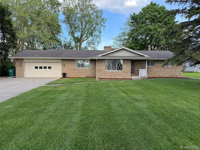 7145 Morrish Rd, Swartz Creek, MI 48473 - ranch-style house with driveway, a chimney, an attached garage, a front yard, and brick siding