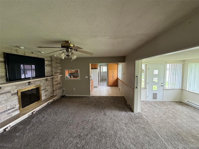 7145 Morrish Rd, Swartz Creek, MI 48473 - unfurnished living room with a textured ceiling, plenty of natural light, carpet, ceiling fan, and a fireplace