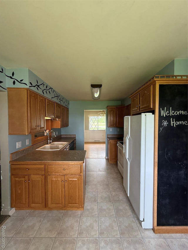 7145 Morrish Rd, Swartz Creek, MI 48473 - kitchen with a sink, white appliances, dark countertops, a peninsula, and brown cabinets