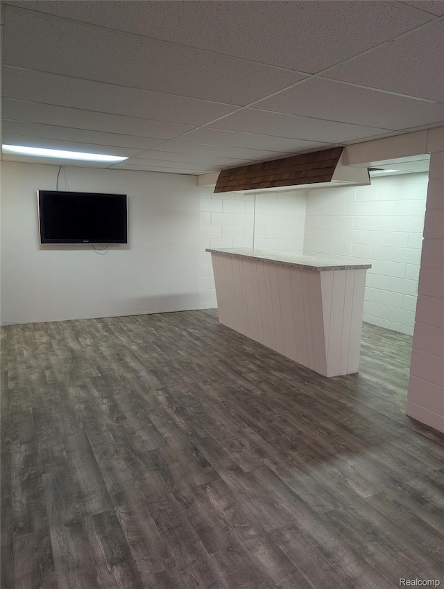 7145 Morrish Rd, Swartz Creek, MI 48473 - finished basement with dark wood-style floors, concrete block wall, a bar, and a drop ceiling