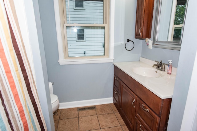 1419 Vassar Dr, Kalamazoo, MI 49001 - bathroom with toilet, vanity, baseboards, and tile patterned flooring