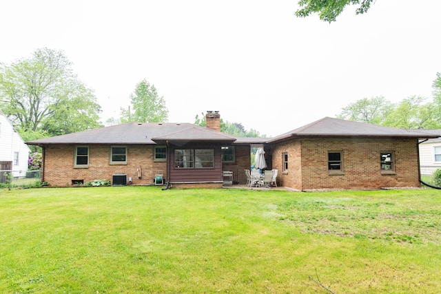 1419 Vassar Dr, Kalamazoo, MI 49001 - rear view of property with brick siding, a chimney, central AC, and a patio area