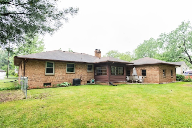 1419 Vassar Dr, Kalamazoo, MI 49001 - rear view of property with brick siding, a chimney, and central AC unit