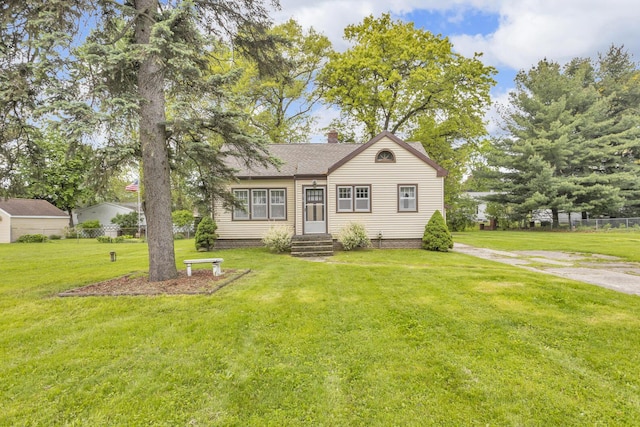 870 Bryant Ave, Jackson, MI 49202 - view of front of home featuring a chimney and a shingled roof