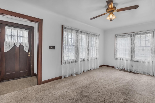 870 Bryant Ave, Jackson, MI 49202 - carpeted foyer with baseboards and a ceiling fan