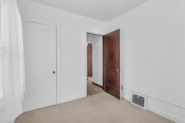 870 Bryant Ave, Jackson, MI 49202 - unfurnished bedroom featuring carpet flooring and arched walkways