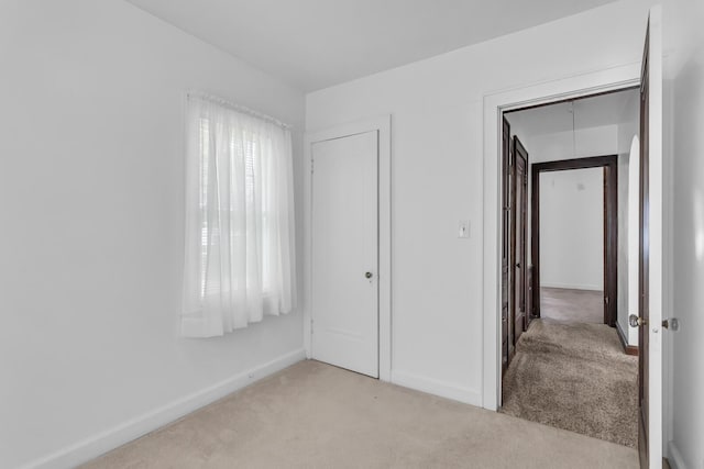 870 Bryant Ave, Jackson, MI 49202 - unfurnished bedroom with light carpet and baseboards