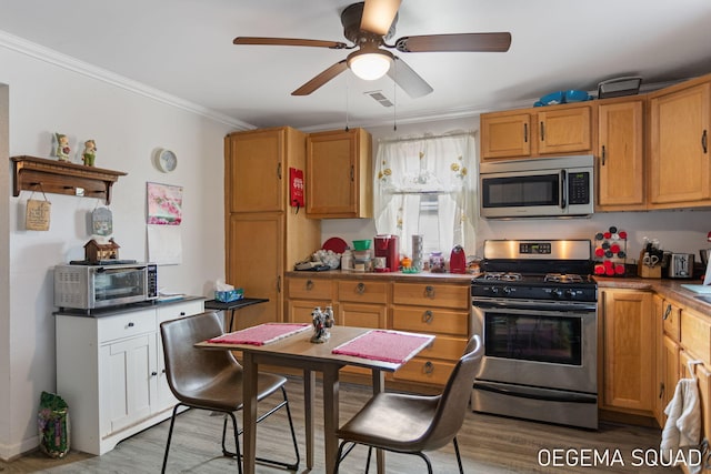 1070 Morningside St, Muskegon, MI 49442 - kitchen featuring stainless steel appliances, a ceiling fan, crown molding, and light wood-style flooring