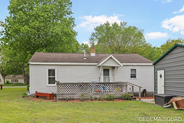 1070 Morningside St, Muskegon, MI 49442 - rear view of house featuring a yard, a chimney, a deck, and roof with shingles
