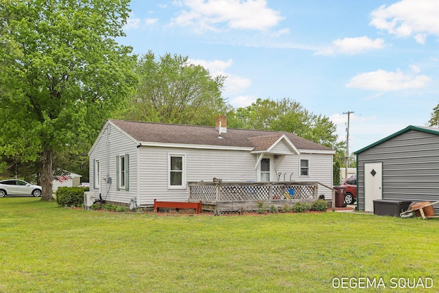 1070 Morningside St, Muskegon, MI 49442 - back of property with a lawn, a wooden deck, a chimney, and roof with shingles