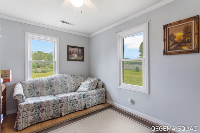 1070 Morningside St, Muskegon, MI 49442 - living area with wood finished floors, ornamental molding, baseboards, and a ceiling fan