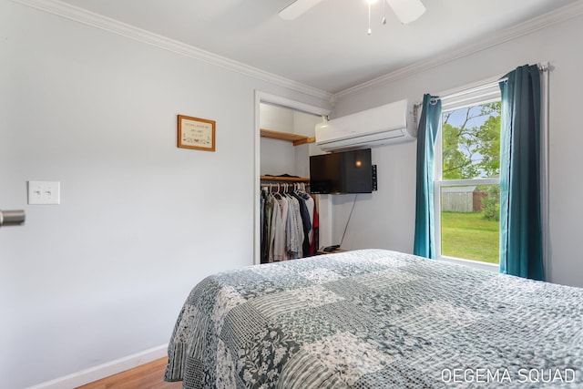 1070 Morningside St, Muskegon, MI 49442 - bedroom with a wall mounted air conditioner, ornamental molding, wood finished floors, a closet, and baseboards