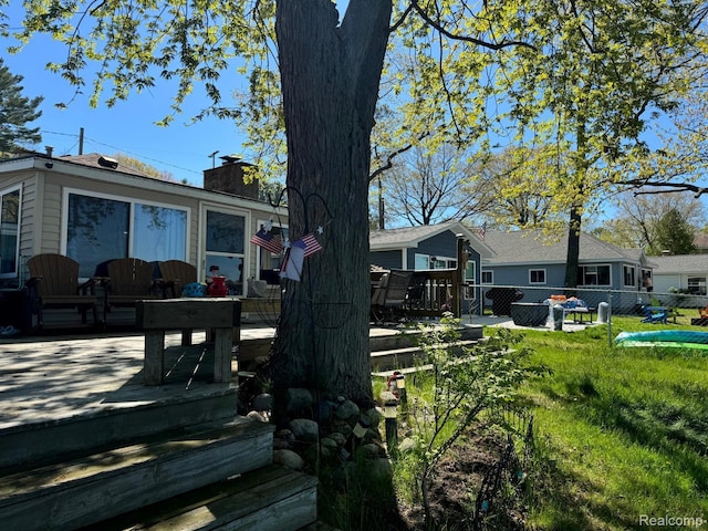 6111 Loud Dr, Oscoda, MI 48750 - exterior space featuring a chimney and a deck