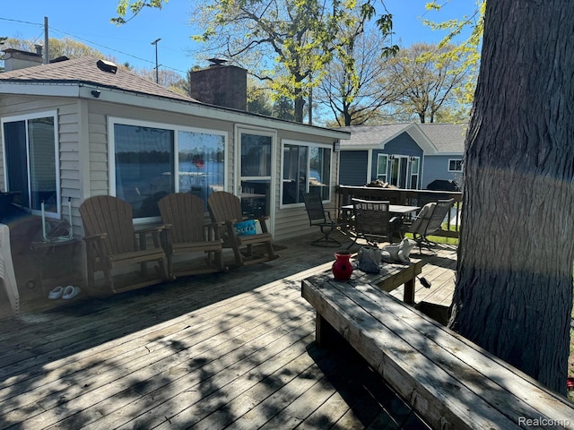 6111 Loud Dr, Oscoda, MI 48750 - wooden deck featuring outdoor dining space