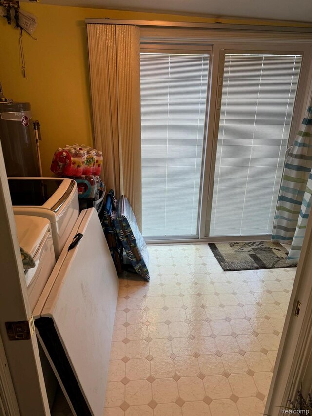 6111 Loud Dr, Oscoda, MI 48750 - interior space with washer and clothes dryer and tile patterned floors