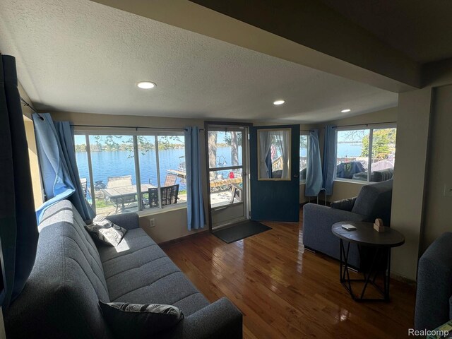 6111 Loud Dr, Oscoda, MI 48750 - living room with a water view, wood finished floors, recessed lighting, and a textured ceiling