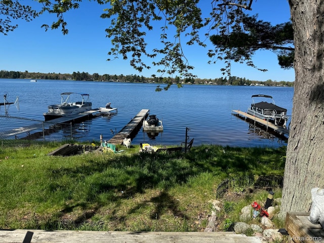 6111 Loud Dr, Oscoda, MI 48750 - dock area featuring a water view