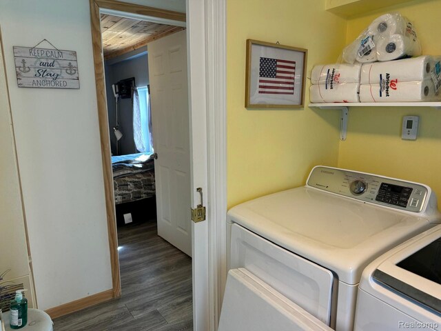 6111 Loud Dr, Oscoda, MI 48750 - laundry area with washer and clothes dryer, dark wood finished floors, and wooden ceiling