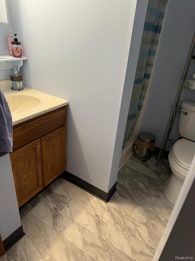 6111 Loud Dr, Oscoda, MI 48750 - bathroom with toilet, a stall shower, vanity, baseboards, and marble look tile flooring