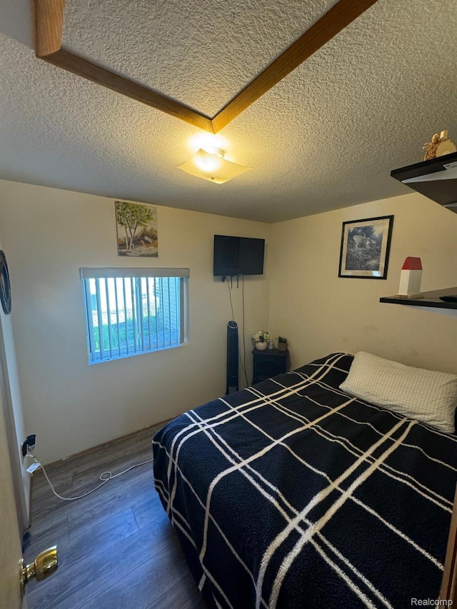 6111 Loud Dr, Oscoda, MI 48750 - bedroom with a textured ceiling and wood finished floors