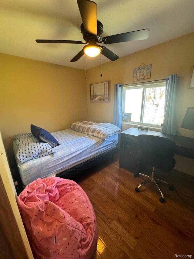 6111 Loud Dr, Oscoda, MI 48750 - bedroom with wood finished floors and a ceiling fan