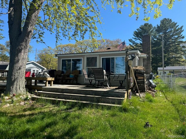 6111 Loud Dr, Oscoda, MI 48750 - rear view of house featuring a deck and a chimney