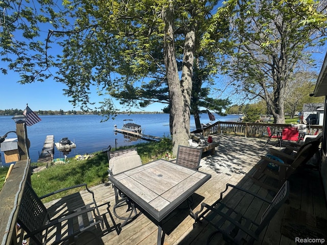6111 Loud Dr, Oscoda, MI 48750 - wooden terrace with a water view, outdoor dining area, and a boat dock