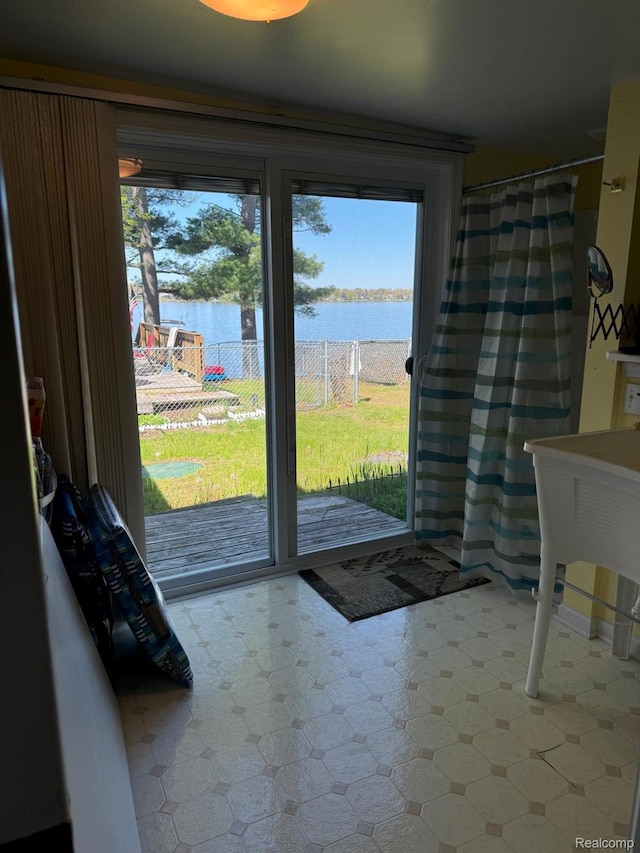 6111 Loud Dr, Oscoda, MI 48750 - doorway with tile patterned floors and a water view