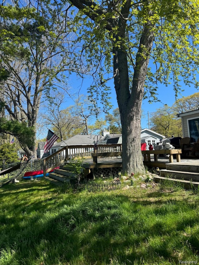6111 Loud Dr, Oscoda, MI 48750 - view of grassy yard with a wooden deck