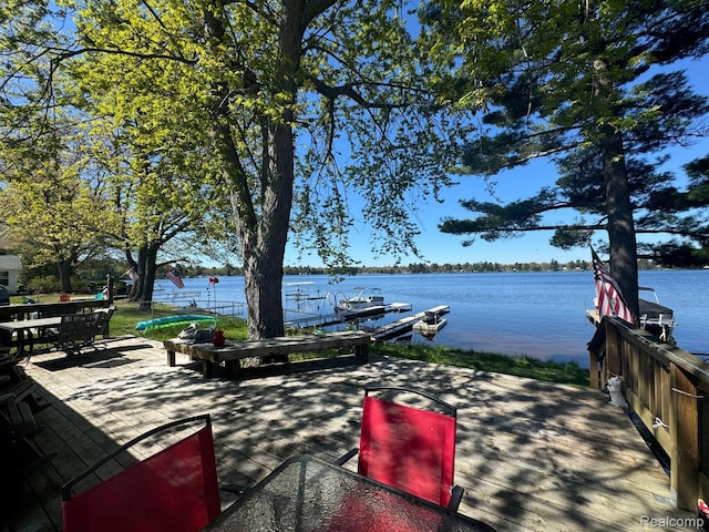 6111 Loud Dr, Oscoda, MI 48750 - dock featuring a water view and outdoor dining area