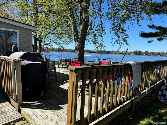 6111 Loud Dr, Oscoda, MI 48750 - wooden deck with a water view and a grill