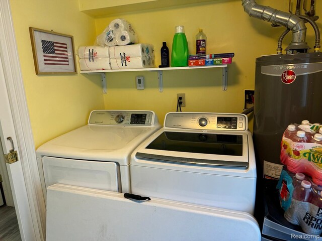 6111 Loud Dr, Oscoda, MI 48750 - laundry room featuring water heater and washer and clothes dryer