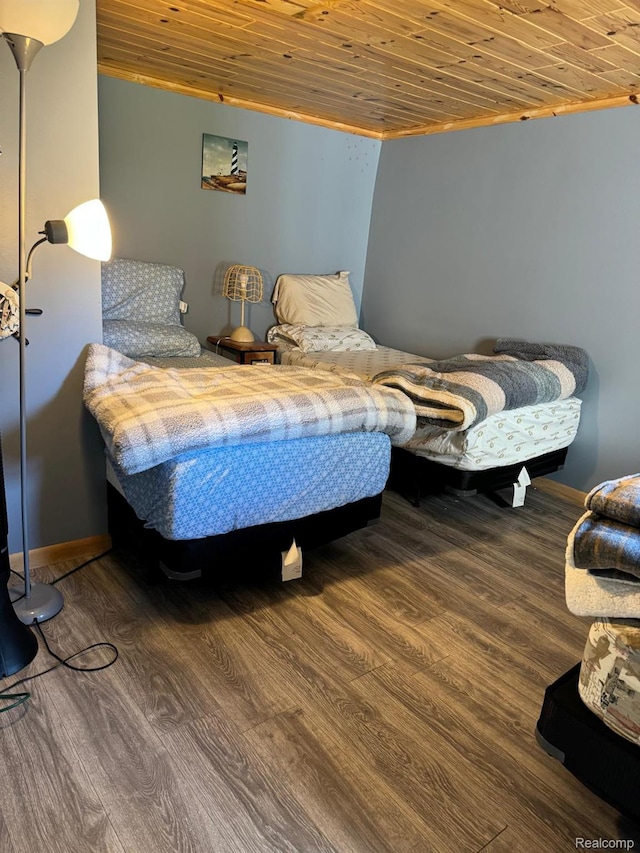 6111 Loud Dr, Oscoda, MI 48750 - bedroom featuring wood ceiling, wood finished floors, and baseboards