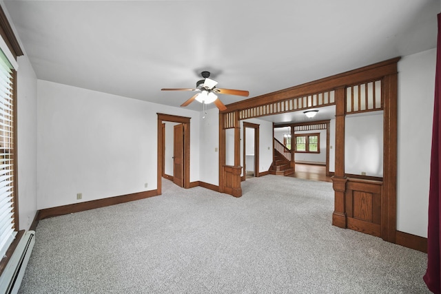 7331 Browns Lake Rd, Jackson, MI 49201 - spare room featuring baseboard heating, carpet, baseboards, stairs, and ceiling fan