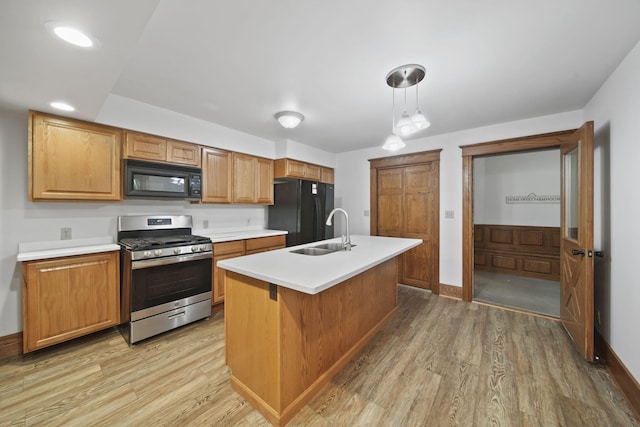 7331 Browns Lake Rd, Jackson, MI 49201 - kitchen featuring black appliances, a sink, light wood-type flooring, and light countertops