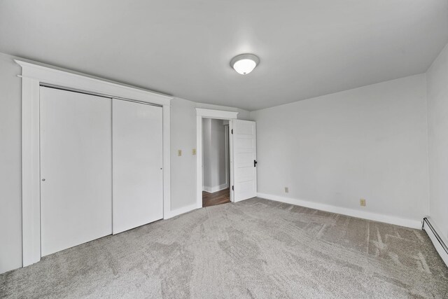 7331 Browns Lake Rd, Jackson, MI 49201 - unfurnished bedroom featuring carpet floors, baseboard heating, baseboards, and a closet