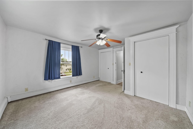 7331 Browns Lake Rd, Jackson, MI 49201 - unfurnished bedroom with baseboard heating, carpet floors, two closets, and ceiling fan
