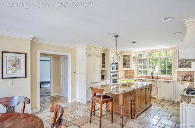 3320 Morningview Ter, Bloomfield Hills, MI 48301 - kitchen with stone tile floors, a kitchen island, decorative backsplash, light stone counters, and crown molding