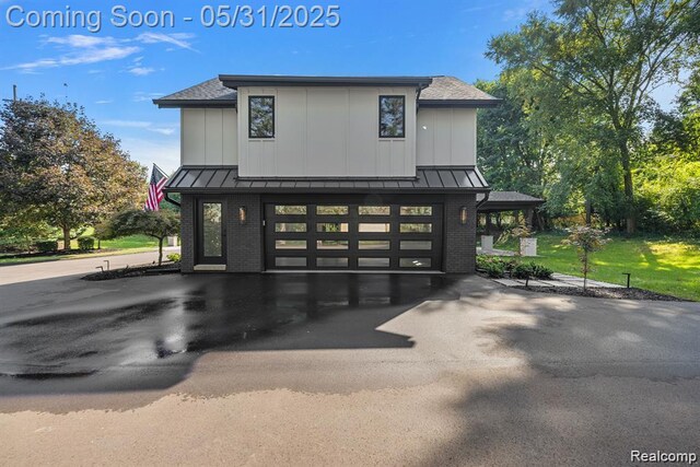 1367 W Long Lake Rd, Bloomfield Hills, MI 48302 - view of front of property featuring a standing seam roof, brick siding, metal roof, board and batten siding, and asphalt driveway